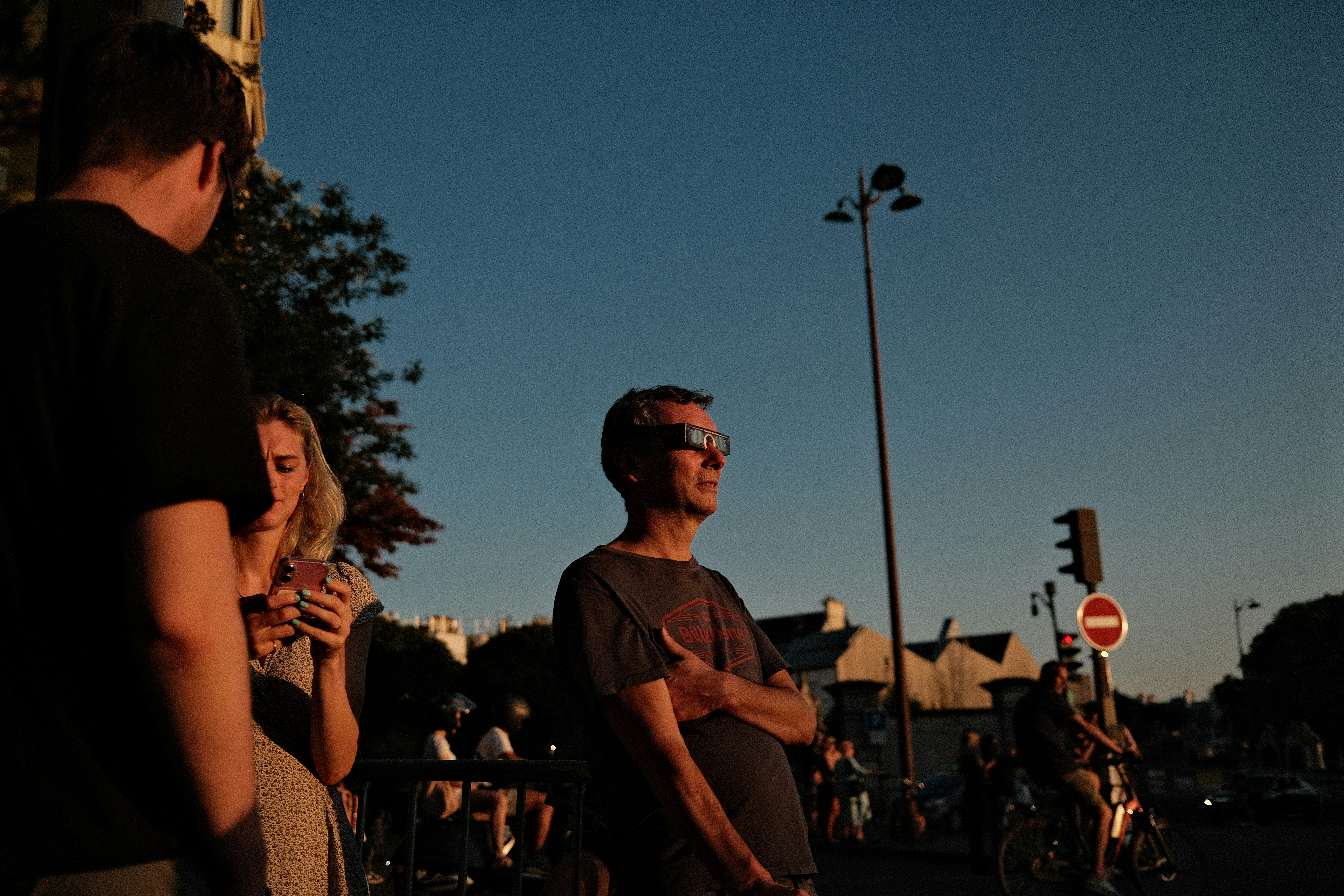 Man watching solar eclipse with safety glasses. Photo by Valentin Lacoste