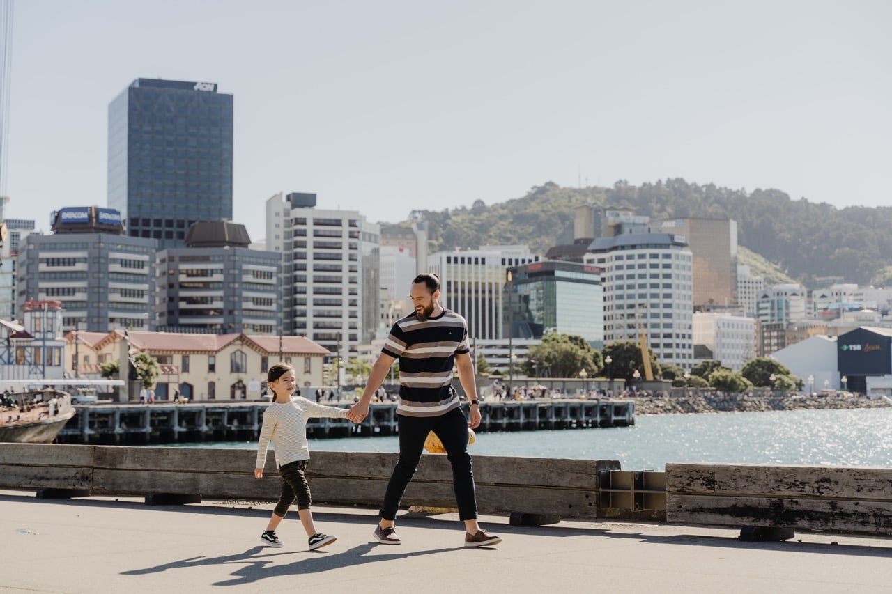 Dad and daughter walking Wellington waterfront in New Zealand. Credit: WellingtonNZ Ryan Domenico