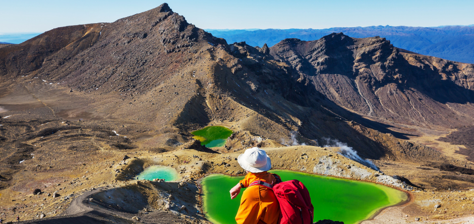 Hiker looking at Emerald pools on Tongariro Crossing
